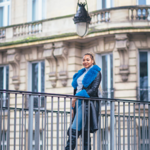 Woman leaning on a balcony in Paris