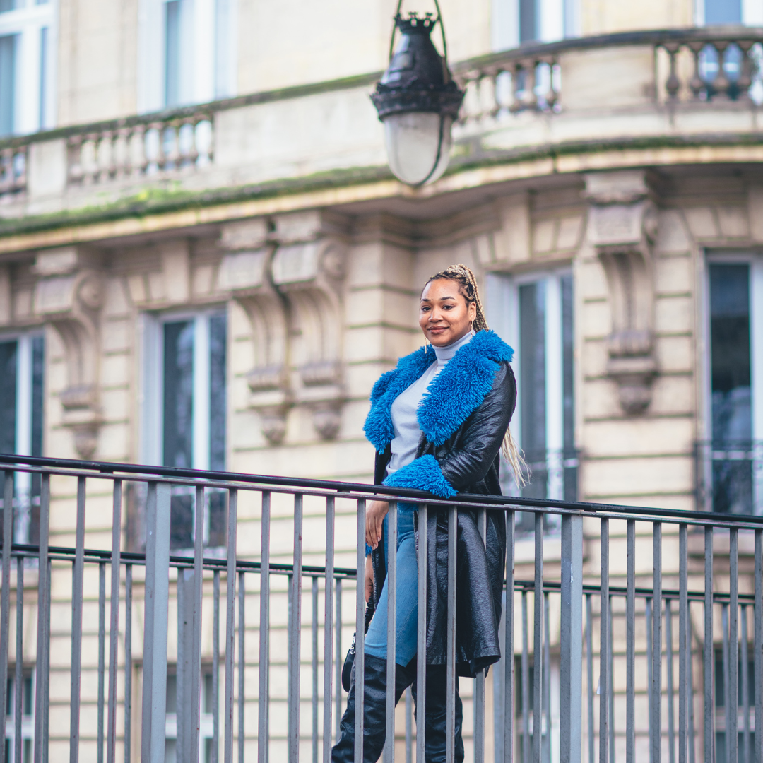 Woman leaning on a balcony in Paris